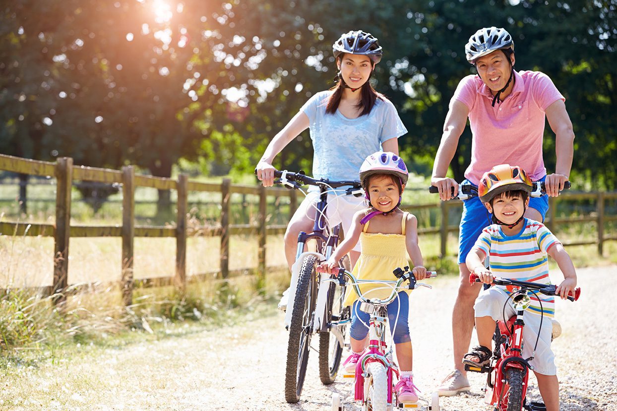 Cummins Facility Services: Happy family, riding bikes, enjoying outdoor activities